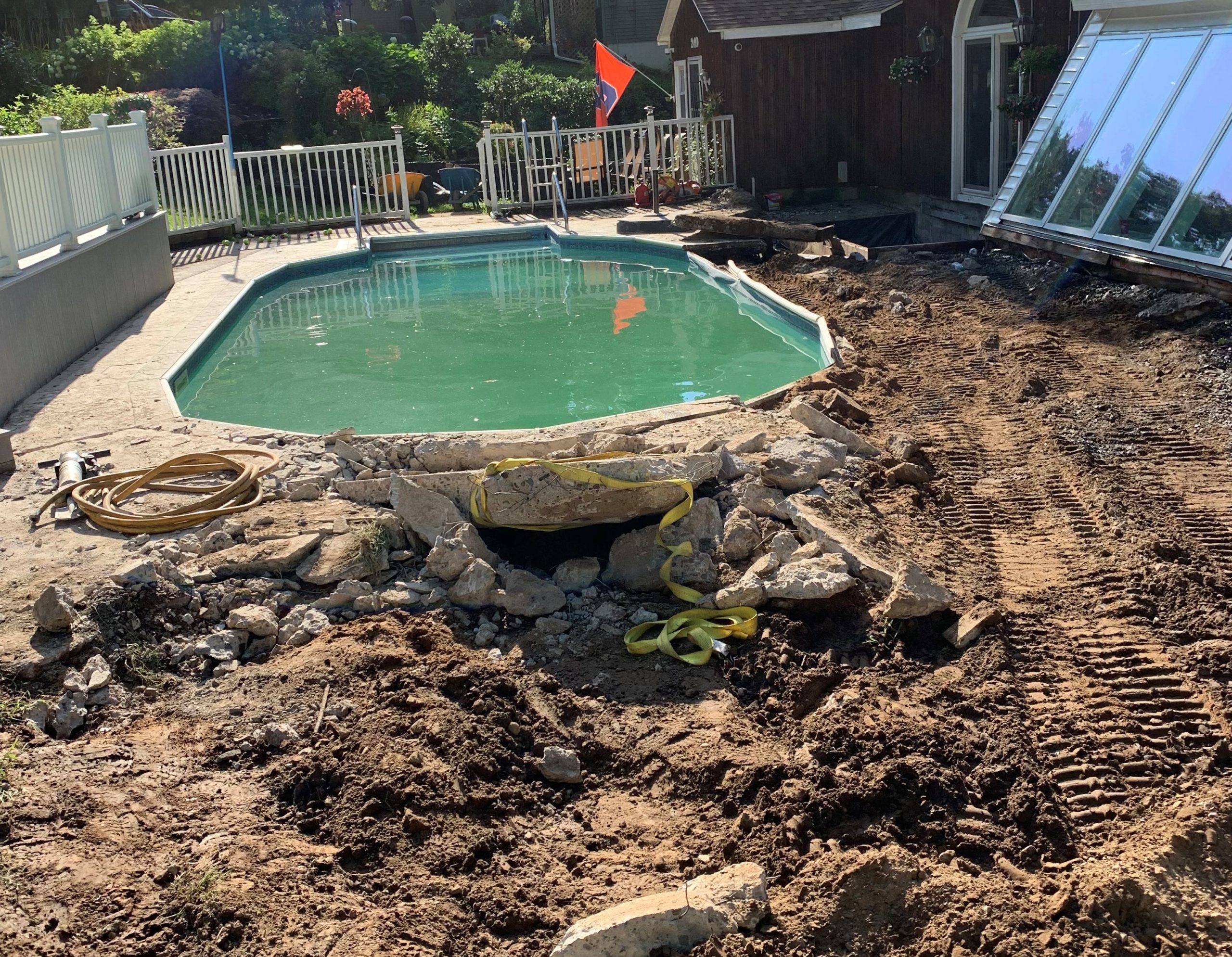 Before: cracked and worn pool deck prior to paver renovation