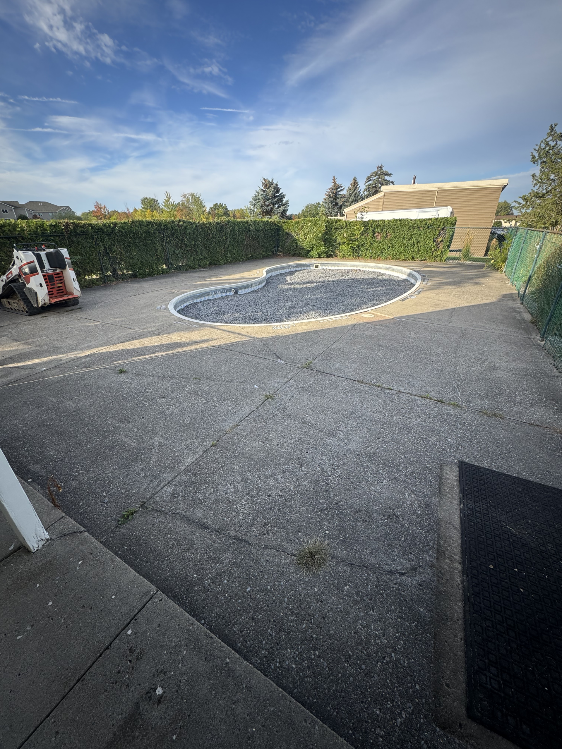 Before: worn pool surround prior to paver pool deck renovation