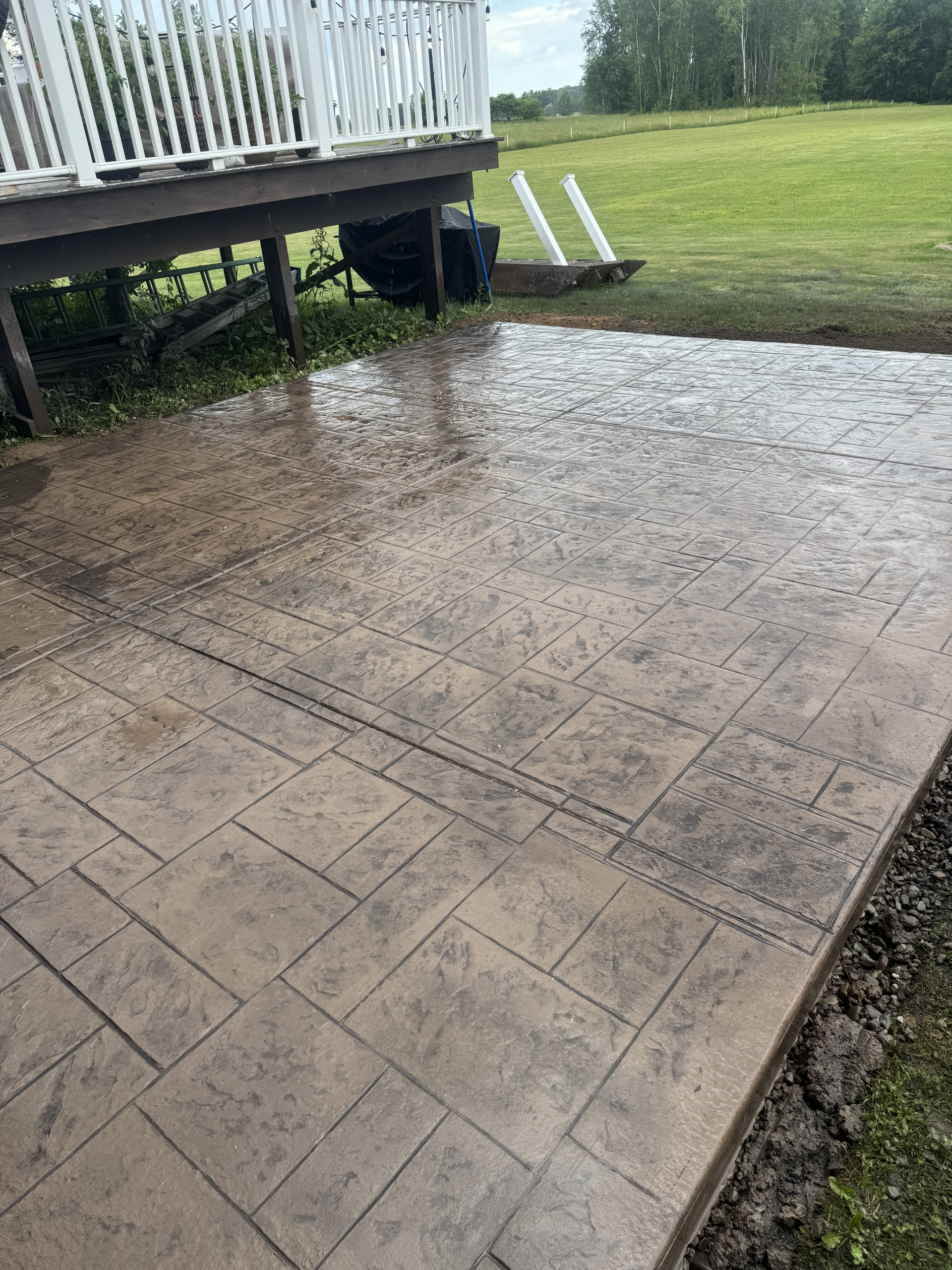 Stamped concrete pool deck and outdoor living space in Central New York